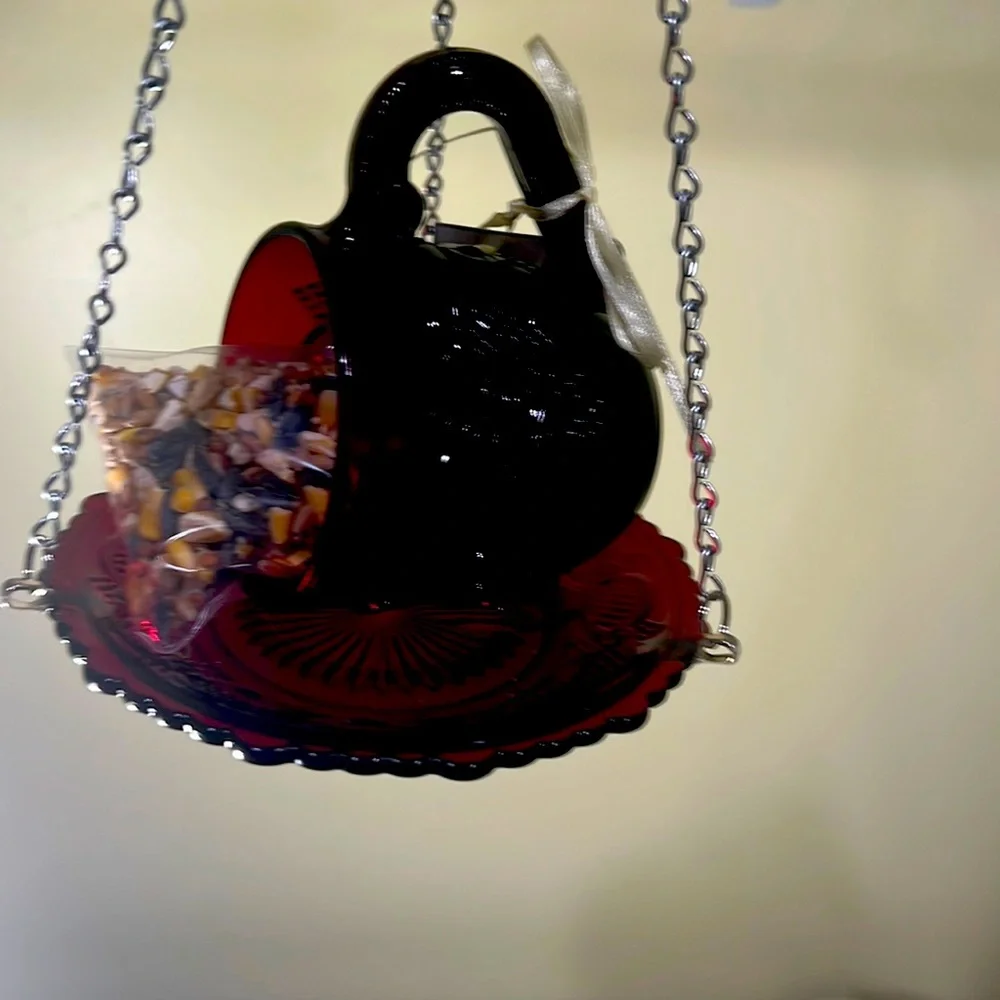 Cup and saucer bird feeder made of vintage glassware.